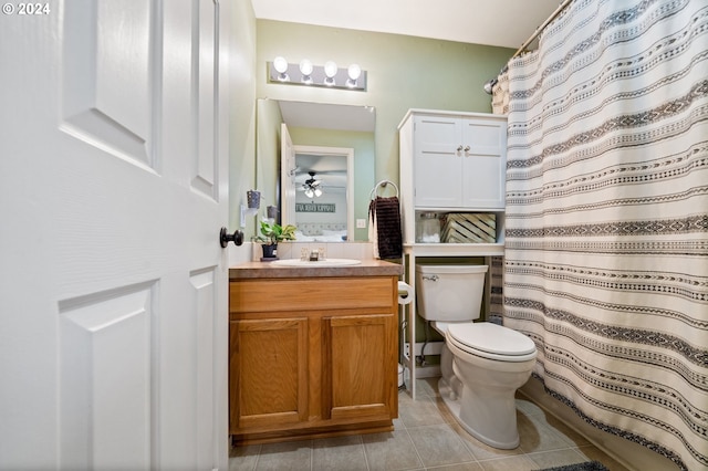 bathroom with tile patterned floors, ceiling fan, vanity, and toilet