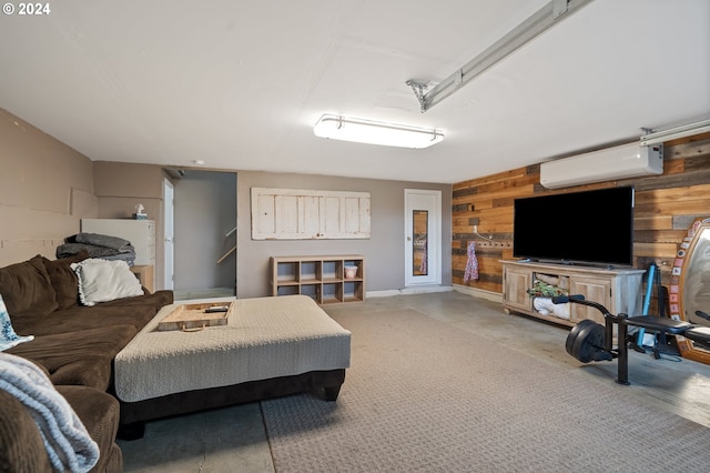 bedroom featuring concrete floors, a wall unit AC, and wooden walls