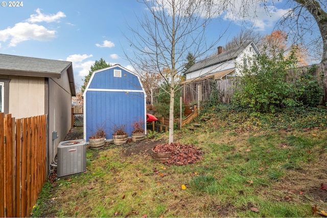 view of yard featuring central AC and a shed