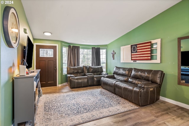 living room featuring hardwood / wood-style flooring and vaulted ceiling