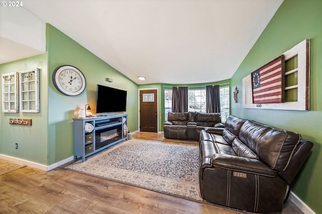 living room featuring hardwood / wood-style floors and vaulted ceiling