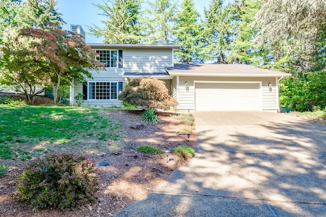 view of front of house with a garage and a front yard