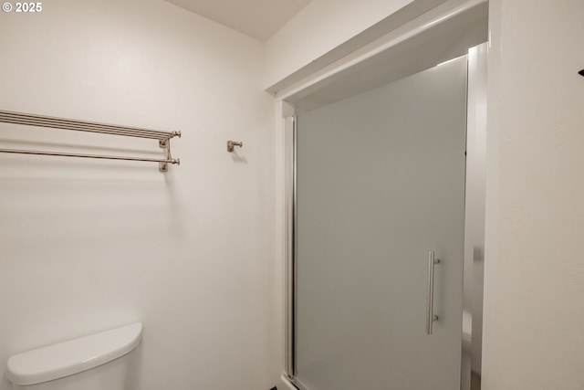 bathroom with walk in shower and toilet