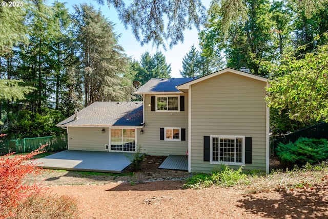 back of property with a patio