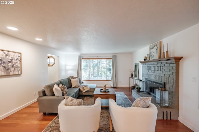 living room with hardwood / wood-style floors and a fireplace