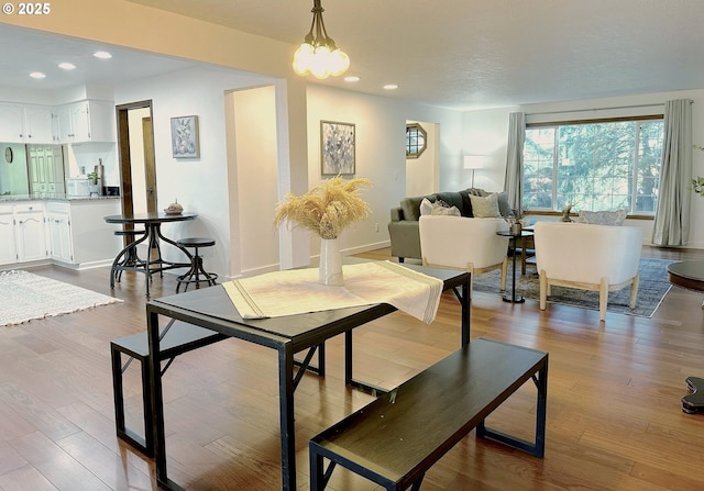 dining room featuring a notable chandelier and light wood-type flooring