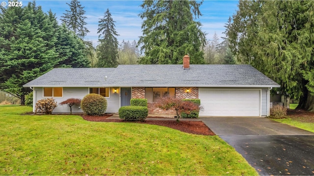 ranch-style home with a front yard and a garage