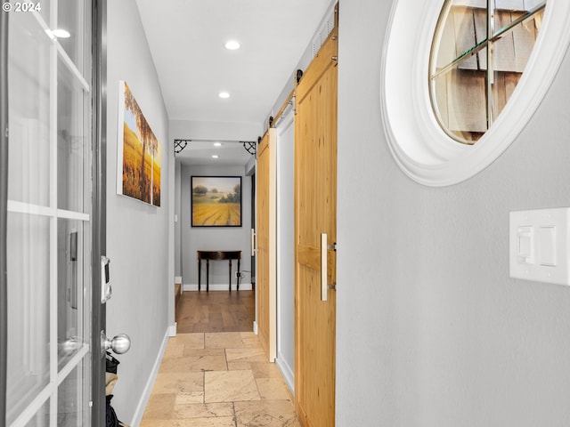 hallway featuring a barn door