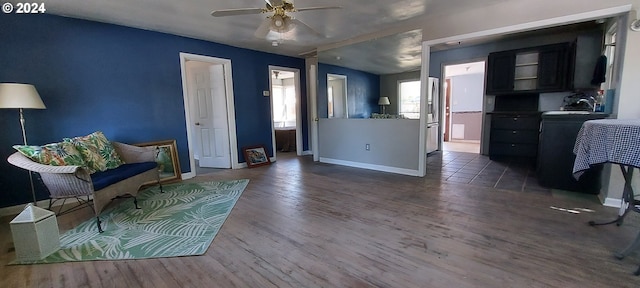 sitting room with dark hardwood / wood-style floors and ceiling fan