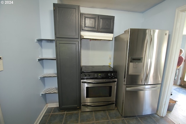 kitchen featuring stainless steel appliances and dark tile patterned flooring