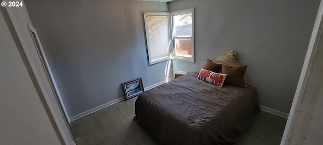 bedroom with hardwood / wood-style flooring