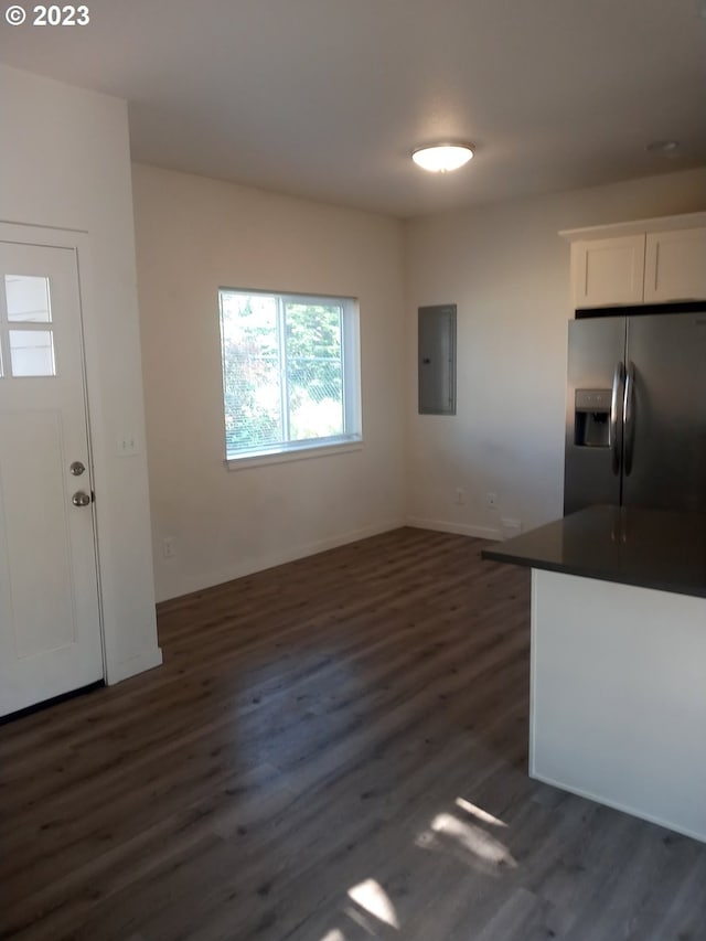 kitchen with white cabinetry, electric panel, stainless steel fridge with ice dispenser, and dark wood-type flooring