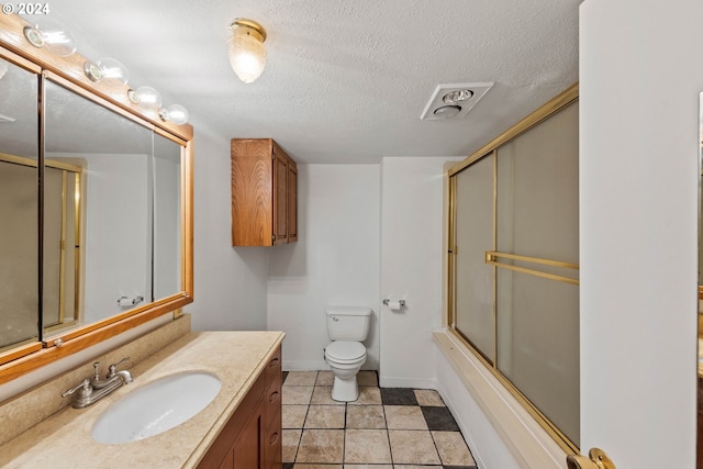 full bathroom with tile patterned floors, toilet, combined bath / shower with glass door, and a textured ceiling