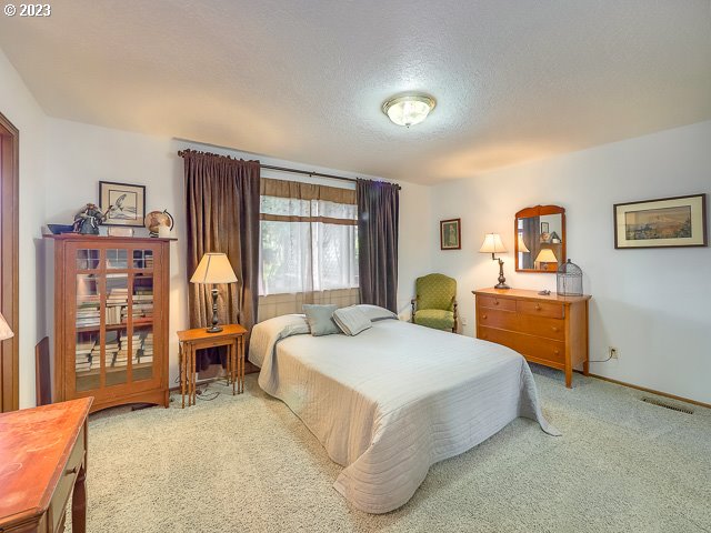 carpeted bedroom with a textured ceiling