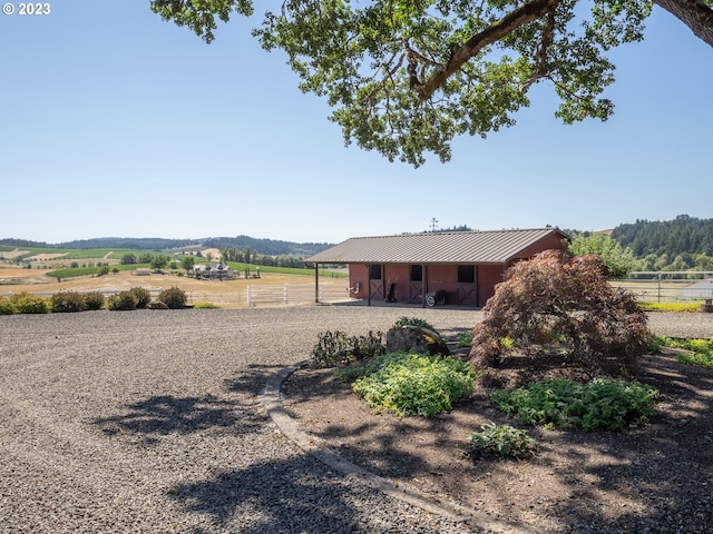 view of yard with an outbuilding and a rural view