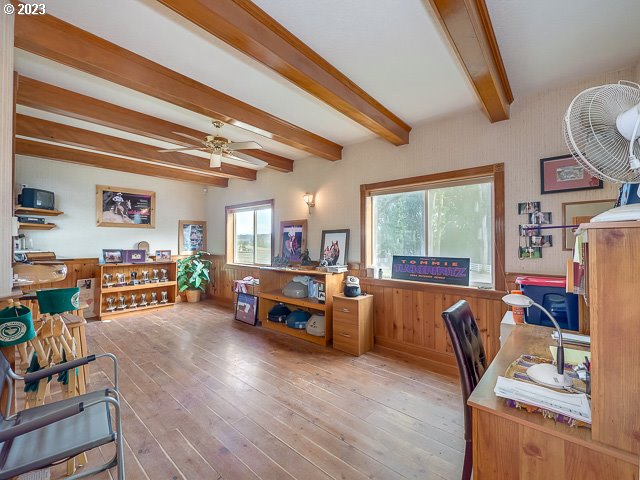 office area with ceiling fan, light wood-type flooring, and beamed ceiling