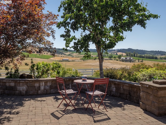 view of patio / terrace with a rural view