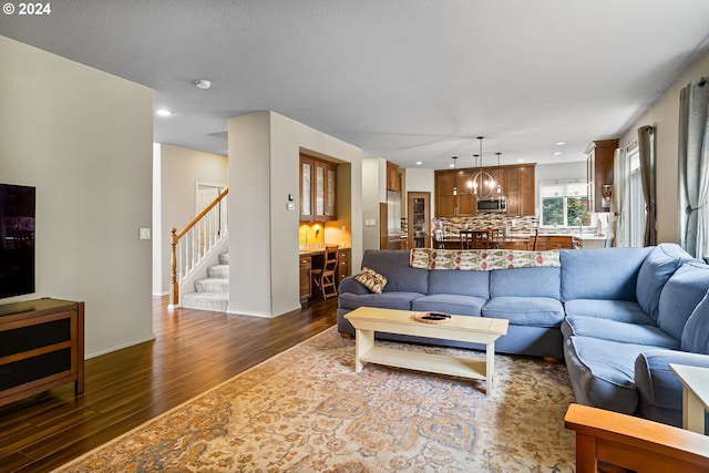 living room featuring a textured ceiling and dark wood-type flooring