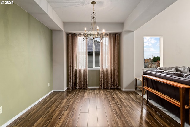 dining room with a chandelier and dark hardwood / wood-style floors