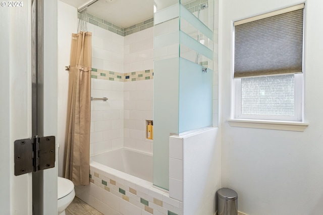 bathroom with shower / tub combo and toilet