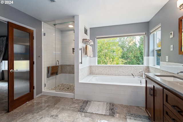 bathroom featuring vanity, plus walk in shower, and french doors