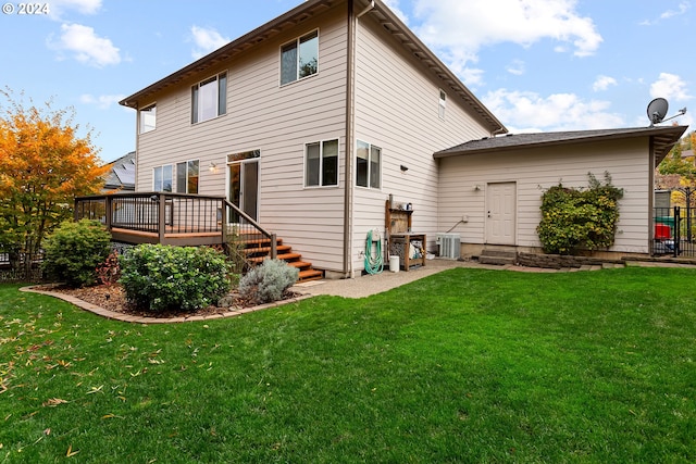 back of property featuring a lawn, central AC unit, and a deck