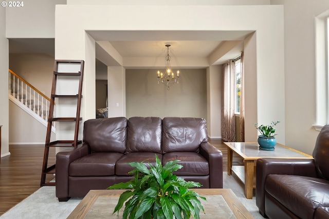 living room featuring wood-type flooring and a notable chandelier