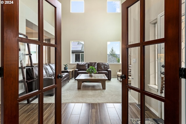 interior space with a high ceiling and hardwood / wood-style flooring