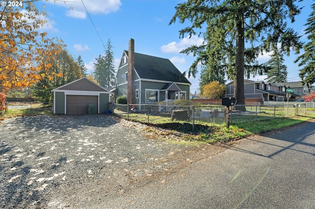 7010 SE Lamphier St, Milwaukie, OR 97222 - view of front facade featuring a garage, a chimney, and an outbuilding