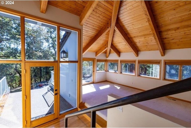 unfurnished sunroom with wooden ceiling, vaulted ceiling with beams, and a wealth of natural light