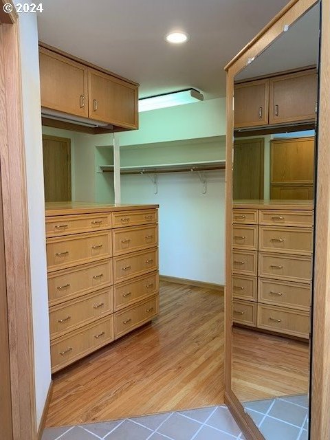 spacious closet featuring light wood-type flooring