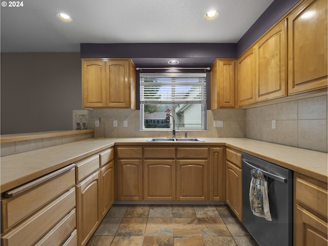 kitchen with tile countertops, dishwasher, decorative backsplash, and sink