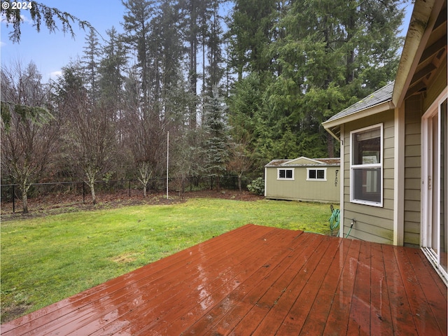 wooden terrace featuring a lawn