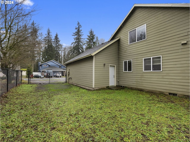 rear view of house with a yard