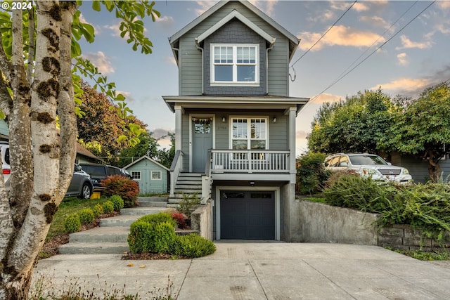 view of front of home featuring a porch and a garage