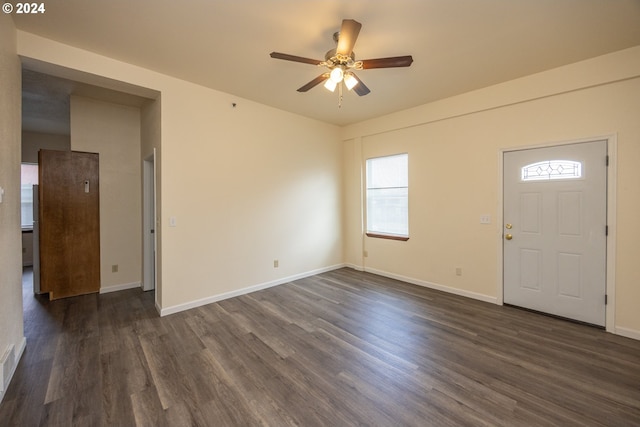 kitchen featuring white appliances, dark hardwood / wood-style floors, light stone countertops, and sink