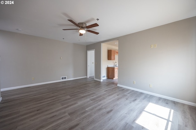 interior space with ensuite bath, hardwood / wood-style flooring, sink, and ceiling fan