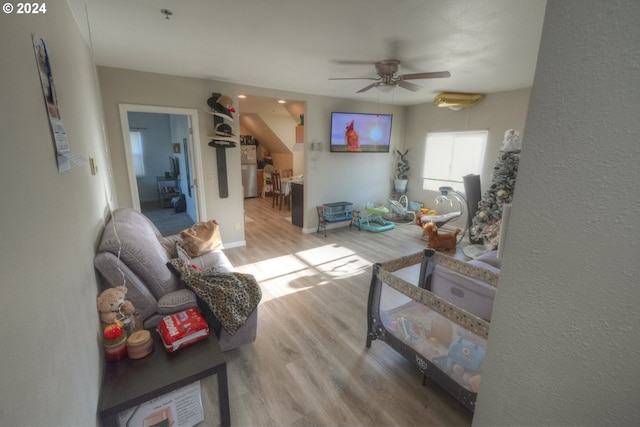 kitchen featuring stainless steel fridge, light hardwood / wood-style floors, and sink