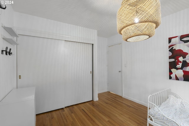 bedroom featuring hardwood / wood-style flooring and a closet