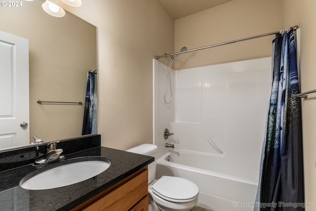 full bathroom with shower / tub combo with curtain, vanity, and toilet