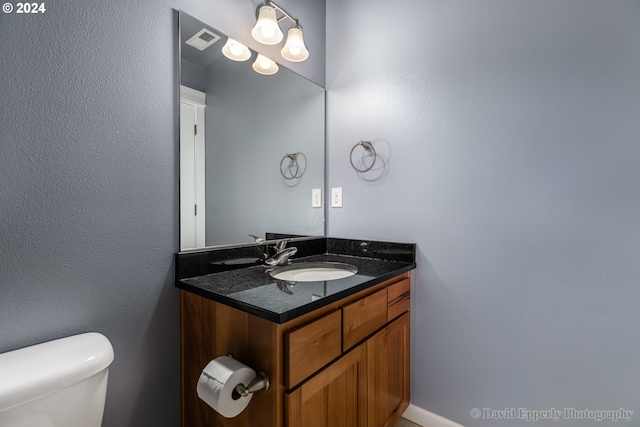 bathroom with toilet and vanity