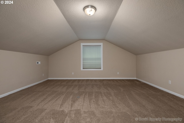 bonus room featuring carpet floors, a textured ceiling, and vaulted ceiling