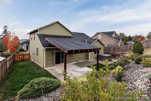 rear view of house with a yard and a patio area