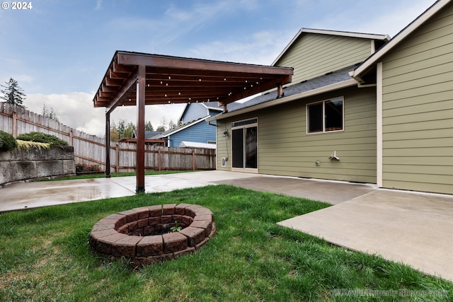 view of yard featuring a fire pit and a patio area