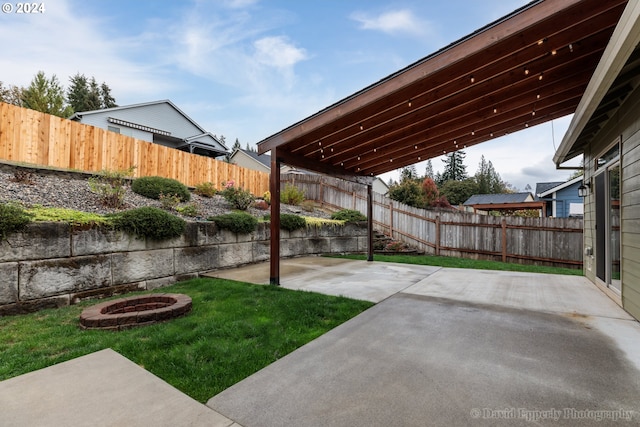 view of yard with a patio and a fire pit