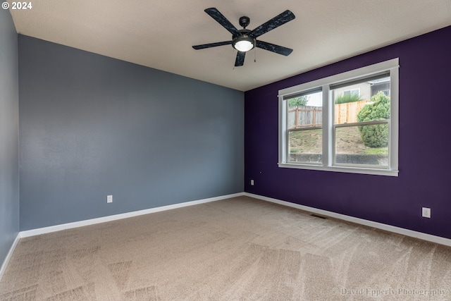 empty room featuring ceiling fan and carpet floors