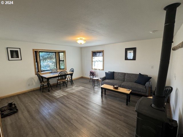 living room with dark hardwood / wood-style flooring and a textured ceiling