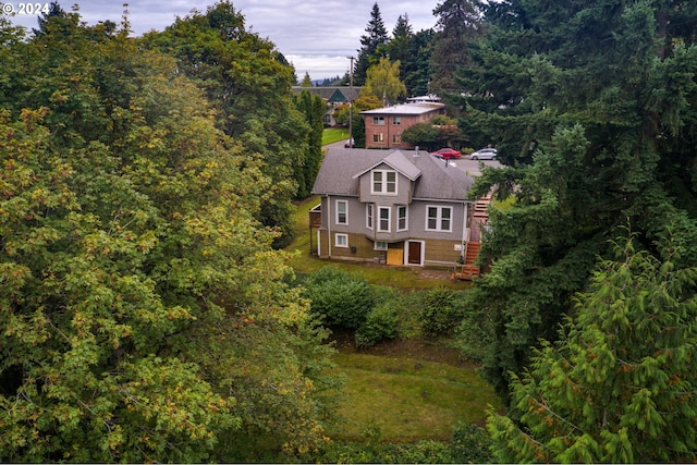 birds eye view of property with a forest view