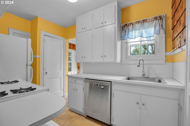 kitchen with dishwasher, light tile patterned flooring, white cabinets, sink, and white fridge