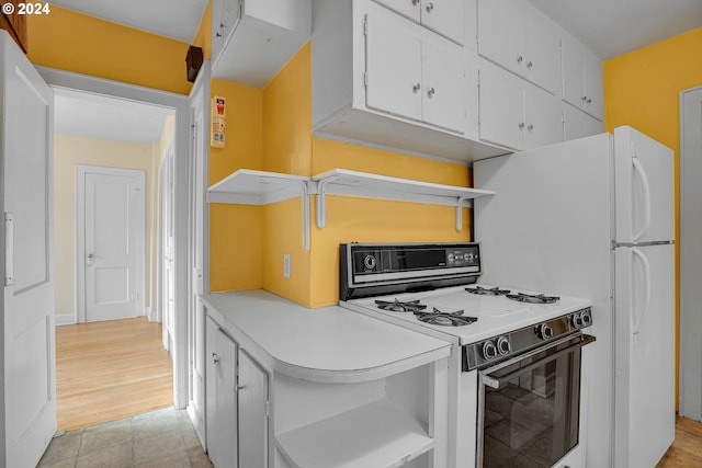 1175 Hines St SE, Salem, OR 97302 - kitchen featuring white gas range oven, open shelves, white cabinets, and light countertops
